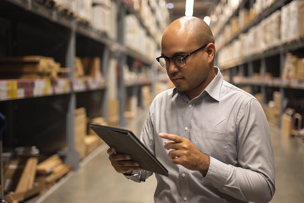 Young manager worker checklist manage parcel box product in ware
